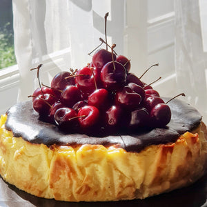Splatter's homemade basque burnt cheesecake topped with premium fresh dark cherries